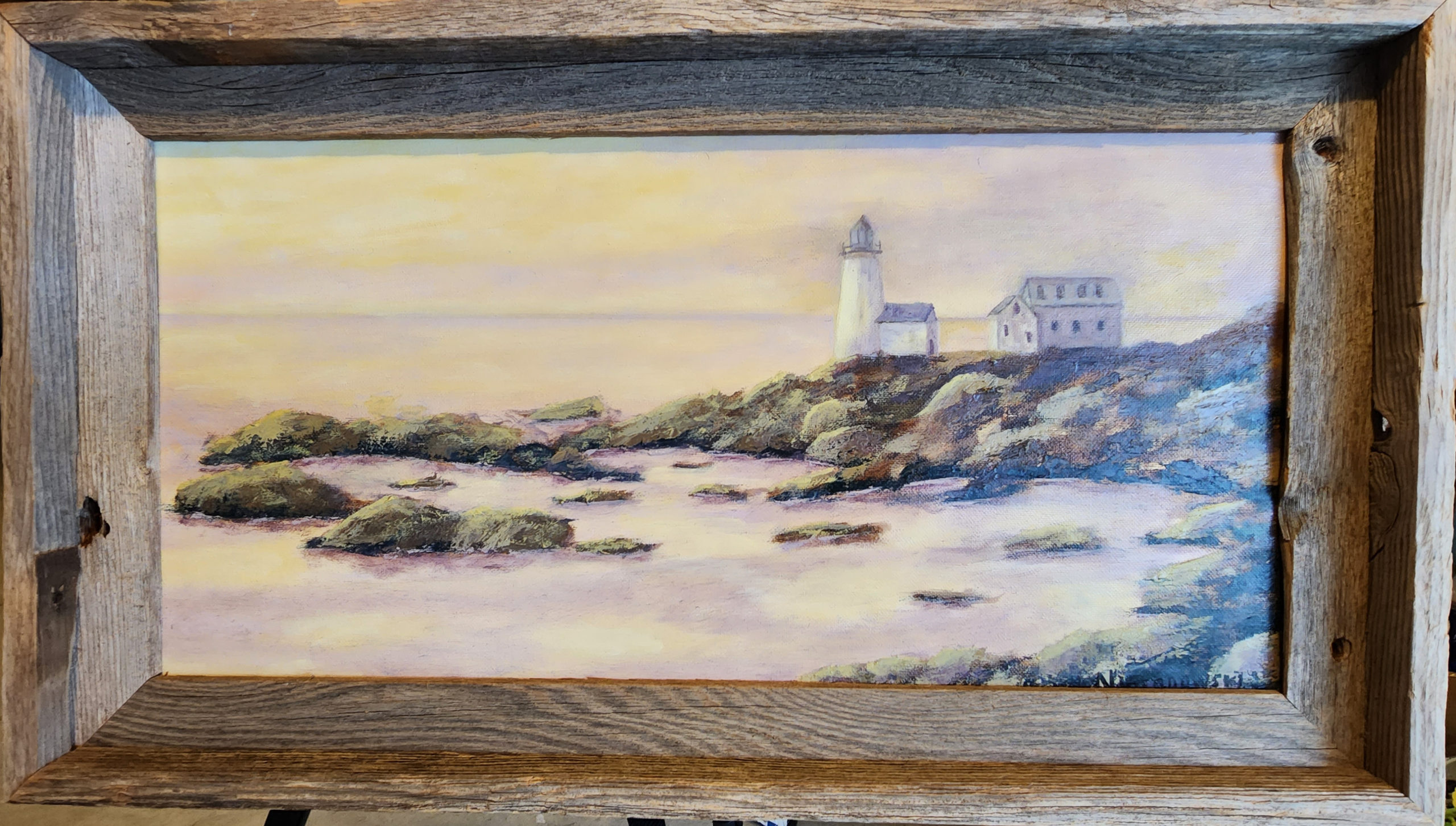 A painting by Bill Nieranowski entitled, "Life on the Rocks," featuring a lighthouse along a rocky coastline in soft light