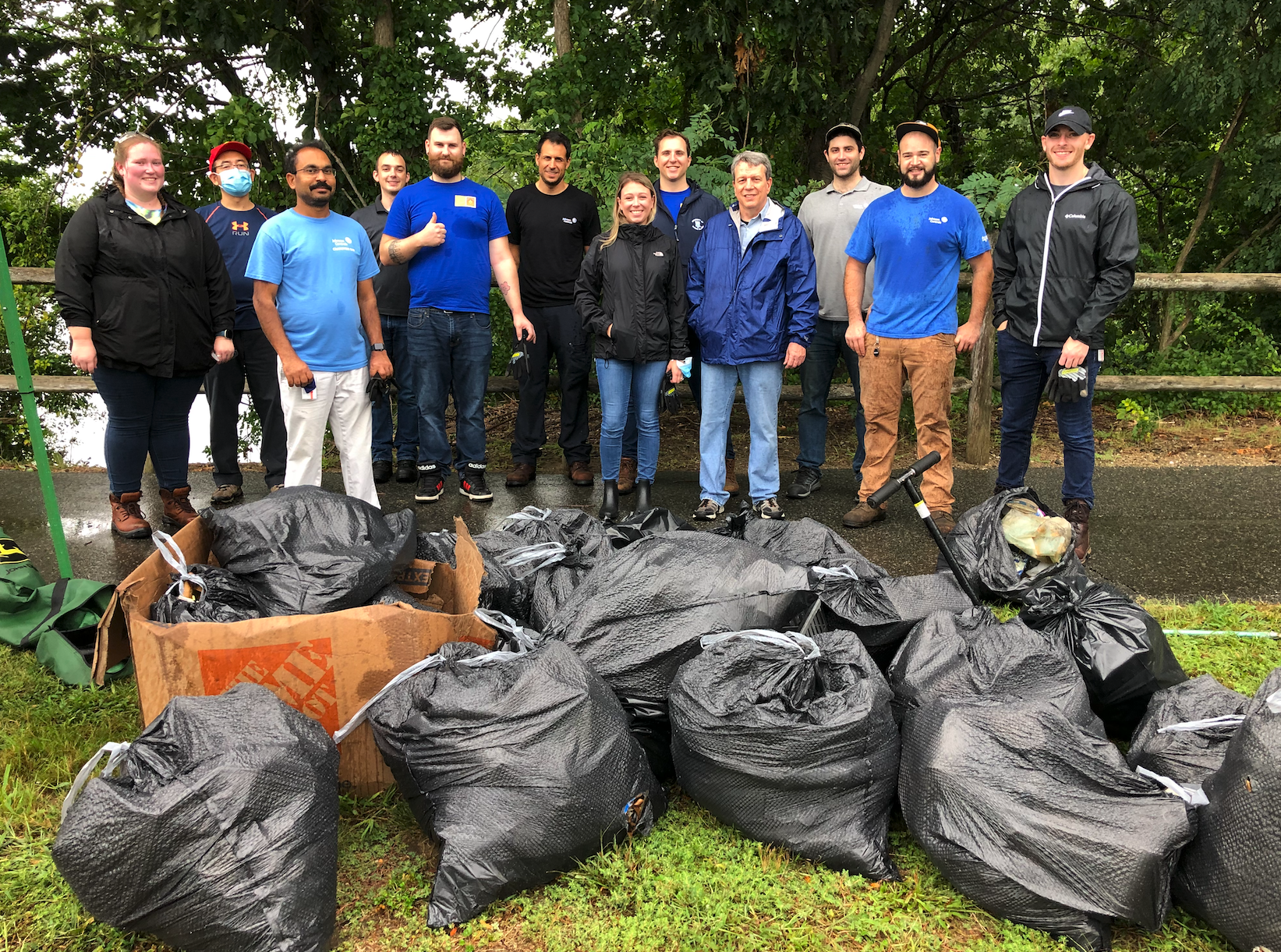 Volunteers-in-front-of-their-collected-trash-at-a-Save-The-Bay-cleanup